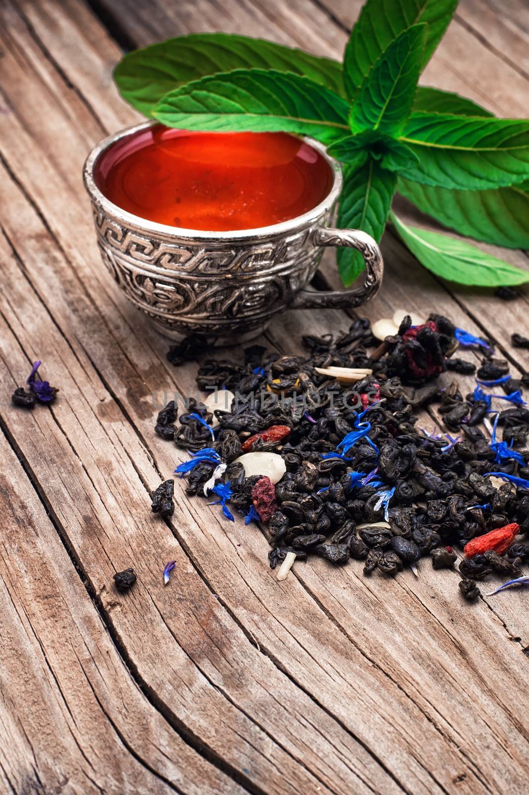 two iron bowls with herbal tea on background of mint leaves.Selective focus