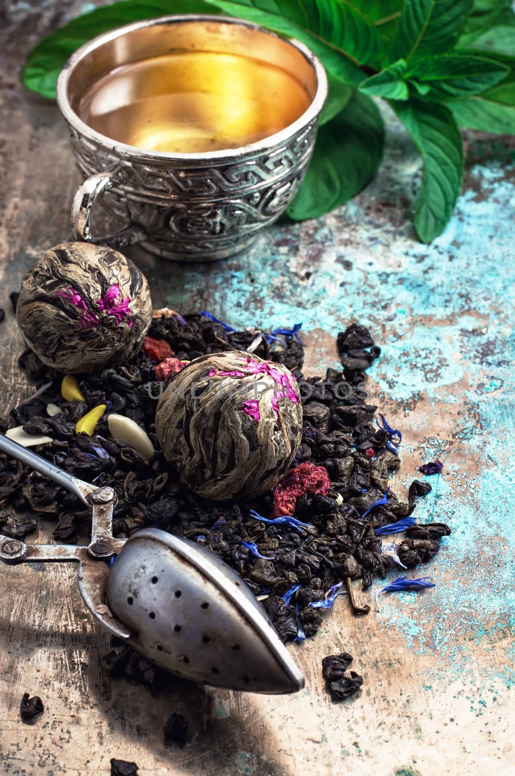 two iron bowls with herbal tea on background of mint leaves.Selective focus