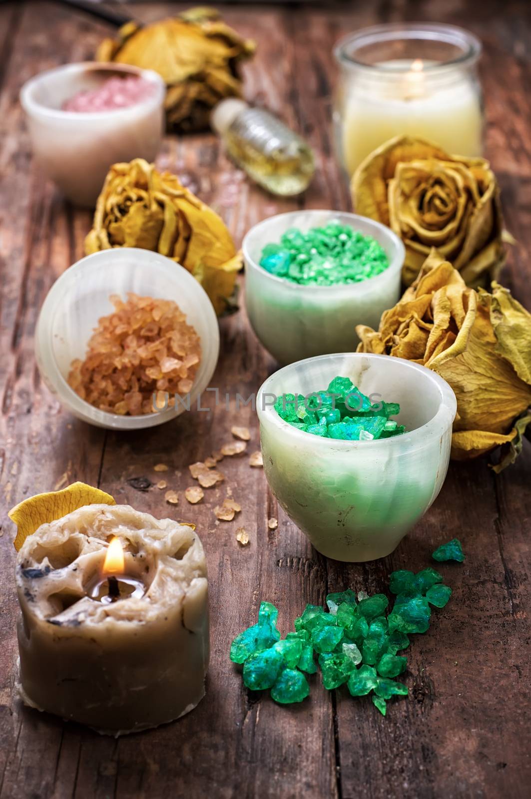 sea salt for Spa treatments with ceramic cups on the background of the buds dried yellow roses