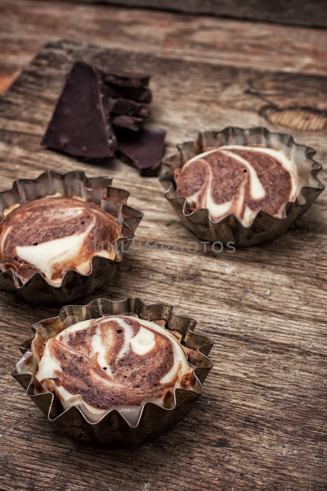 baked chocolate dessert in the iron forms on wooden surface