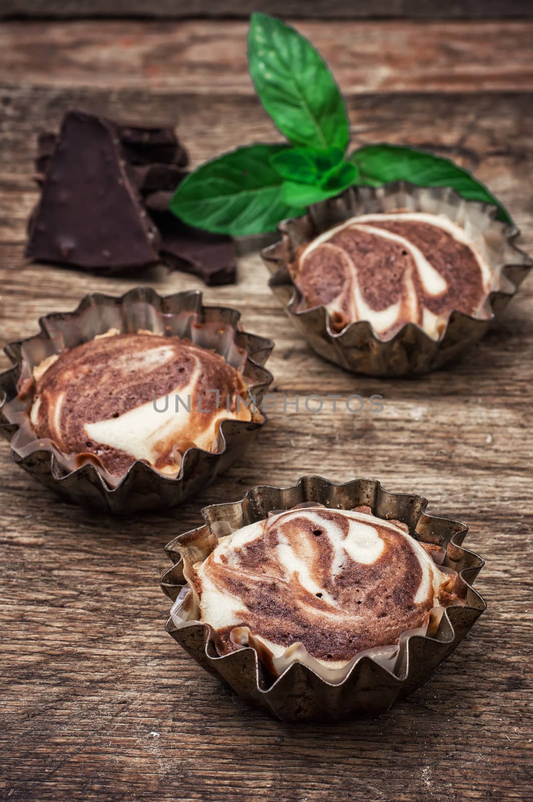 baked chocolate dessert in the iron forms on wooden surface