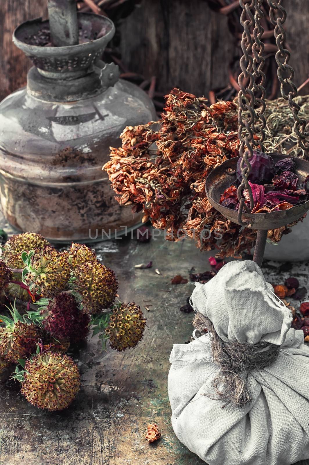 assembled the dried yield healing herbs traditional medicine and vintage kerosene lamp.Photo tinted.Selective focus