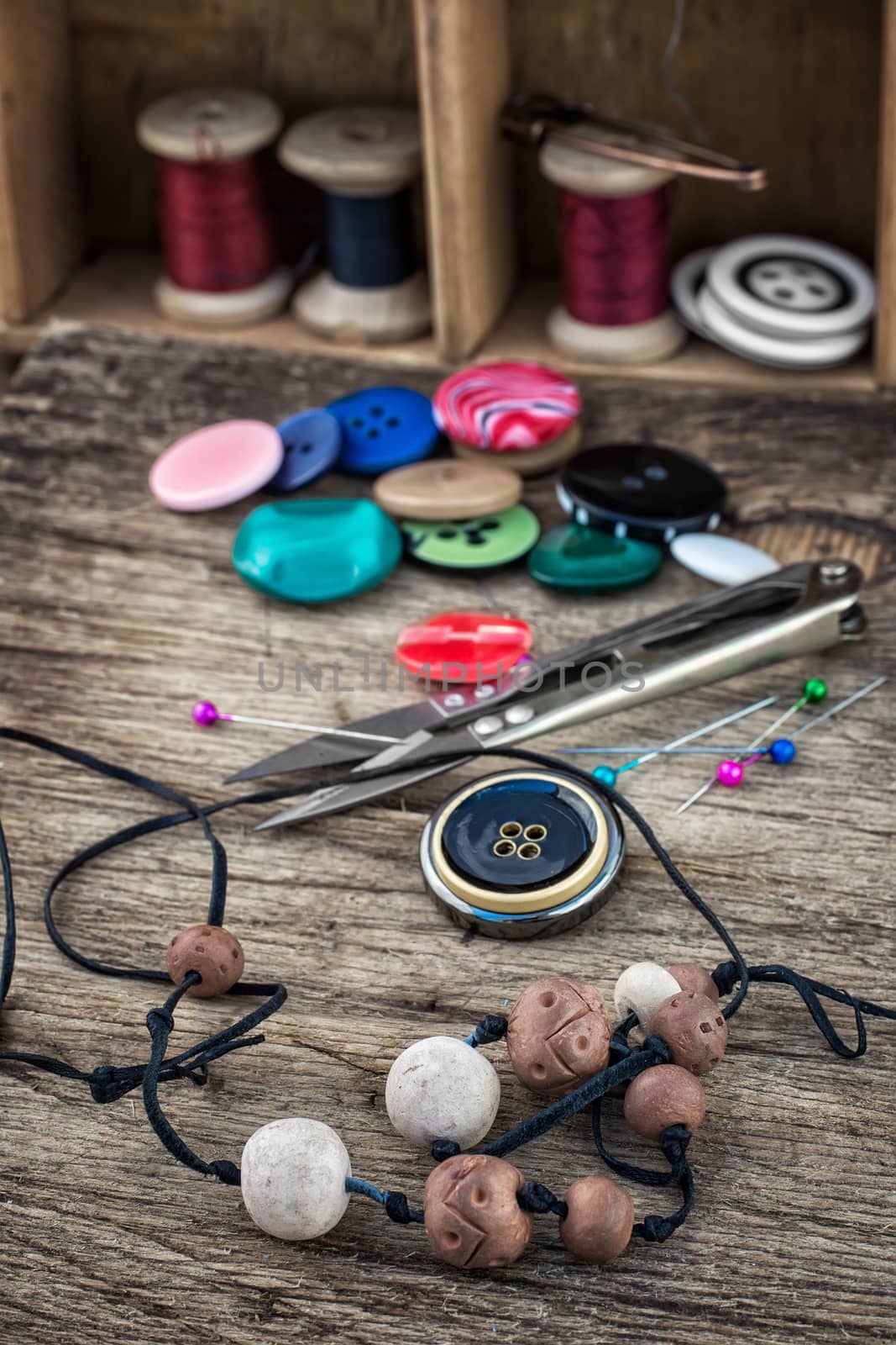different tools for needlework beading and sewing in vintage style.Selective focus.Photo tinted