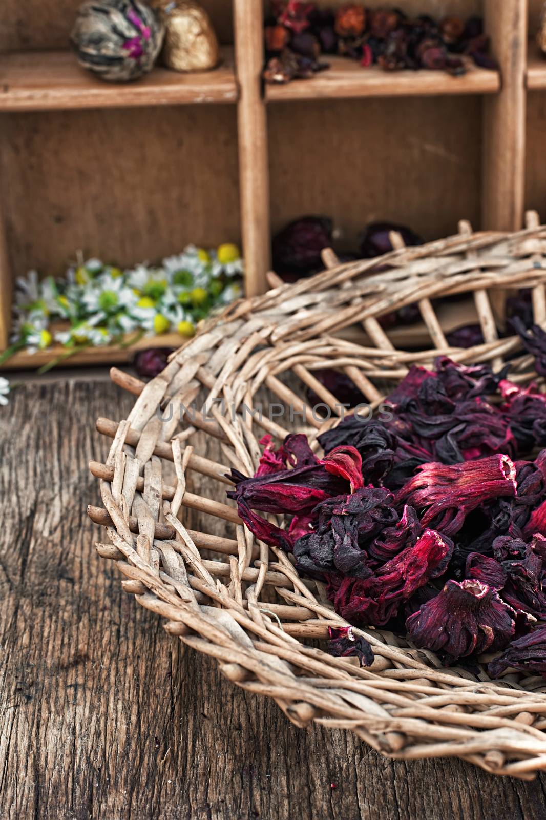 Hibiscus tea rose and welding on the background of the tea shelves in vintage style.Photo tinted