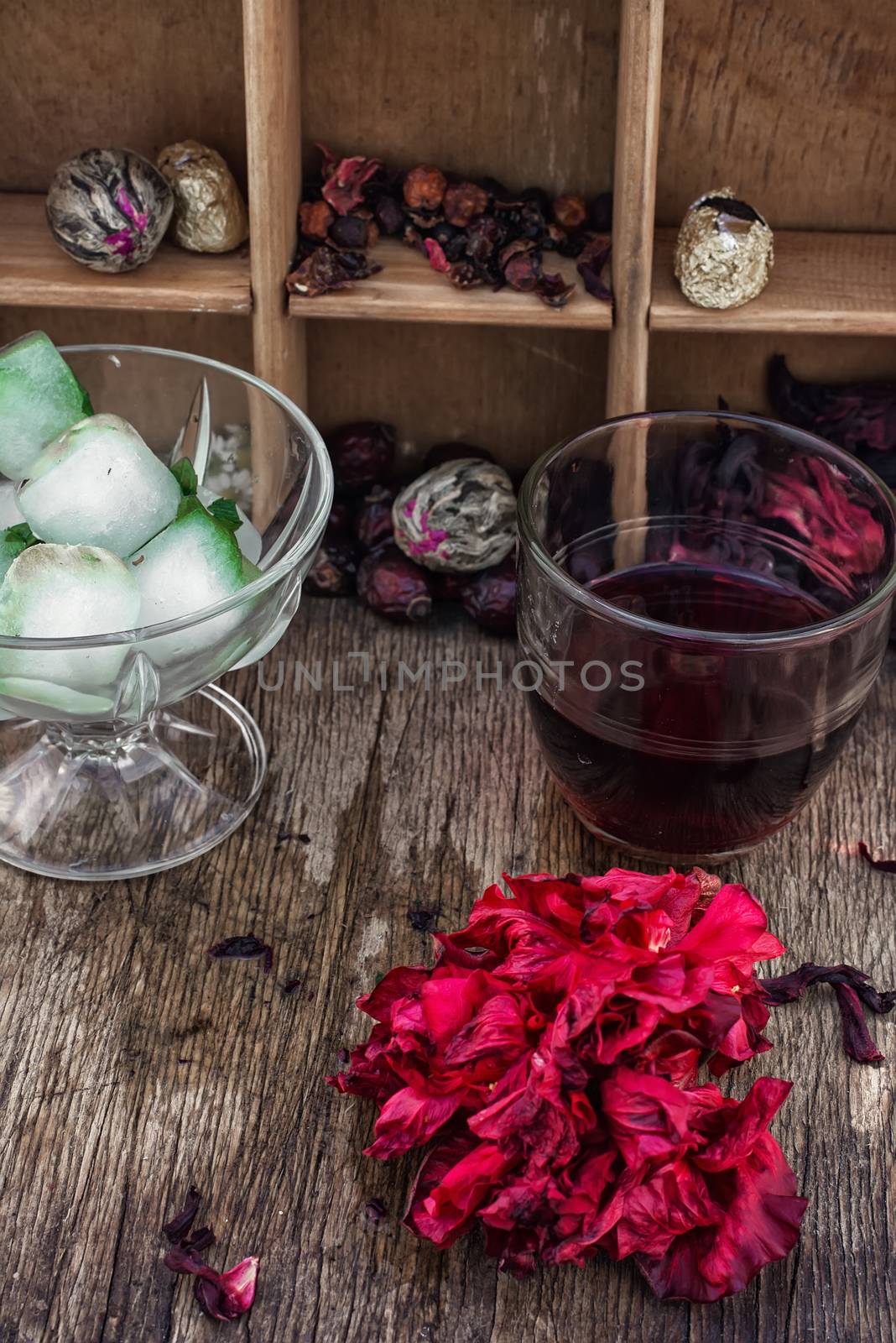 Hibiscus tea rose and welding on the background of the tea shelves in vintage style.Photo tinted