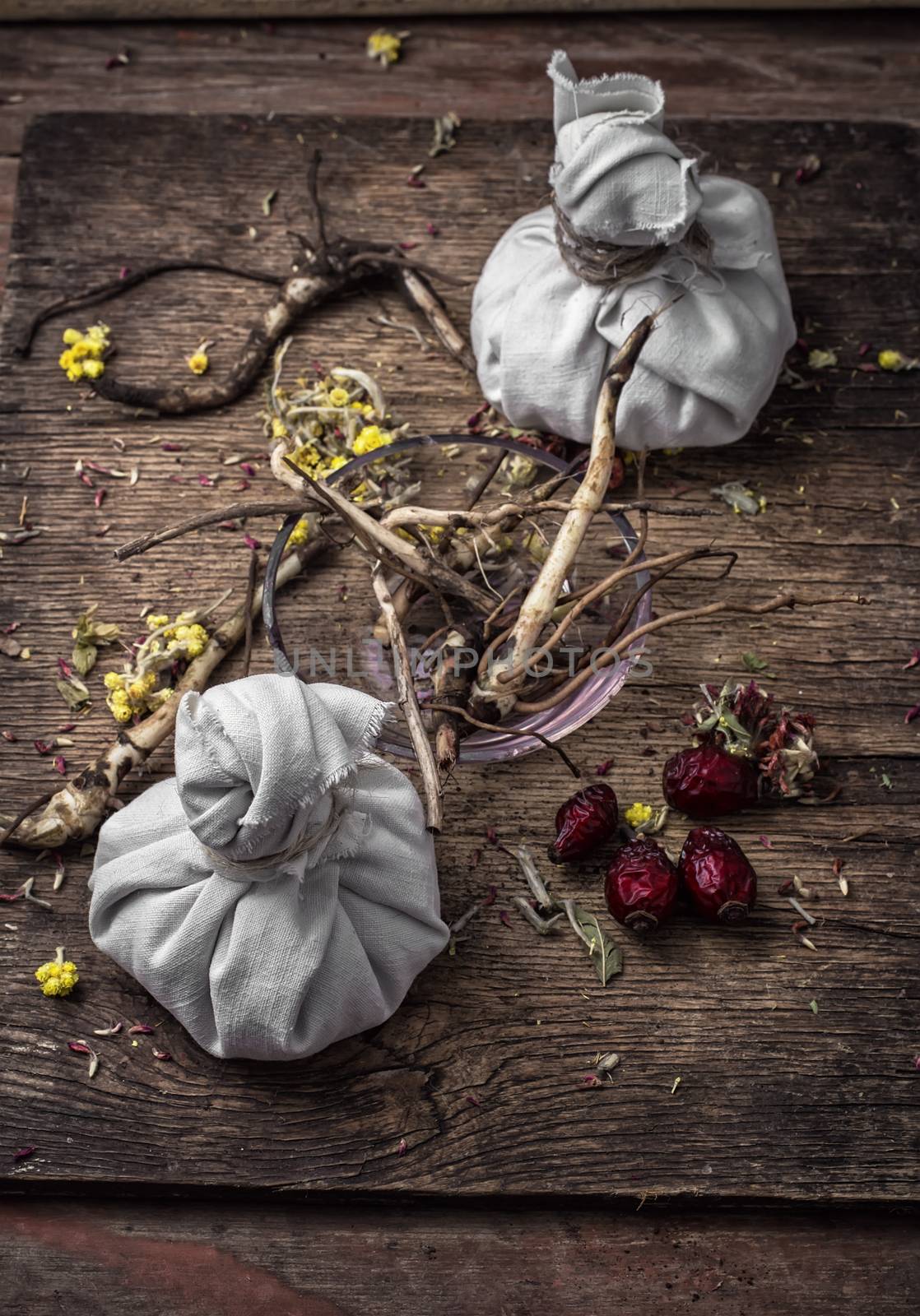 two bags  prepared medicinal plants on the table of the healer