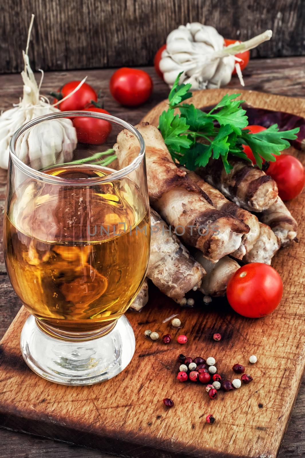 fragrant grilled meat sausages in tomato with a glass of light beer.Selective focus.Photo tinted