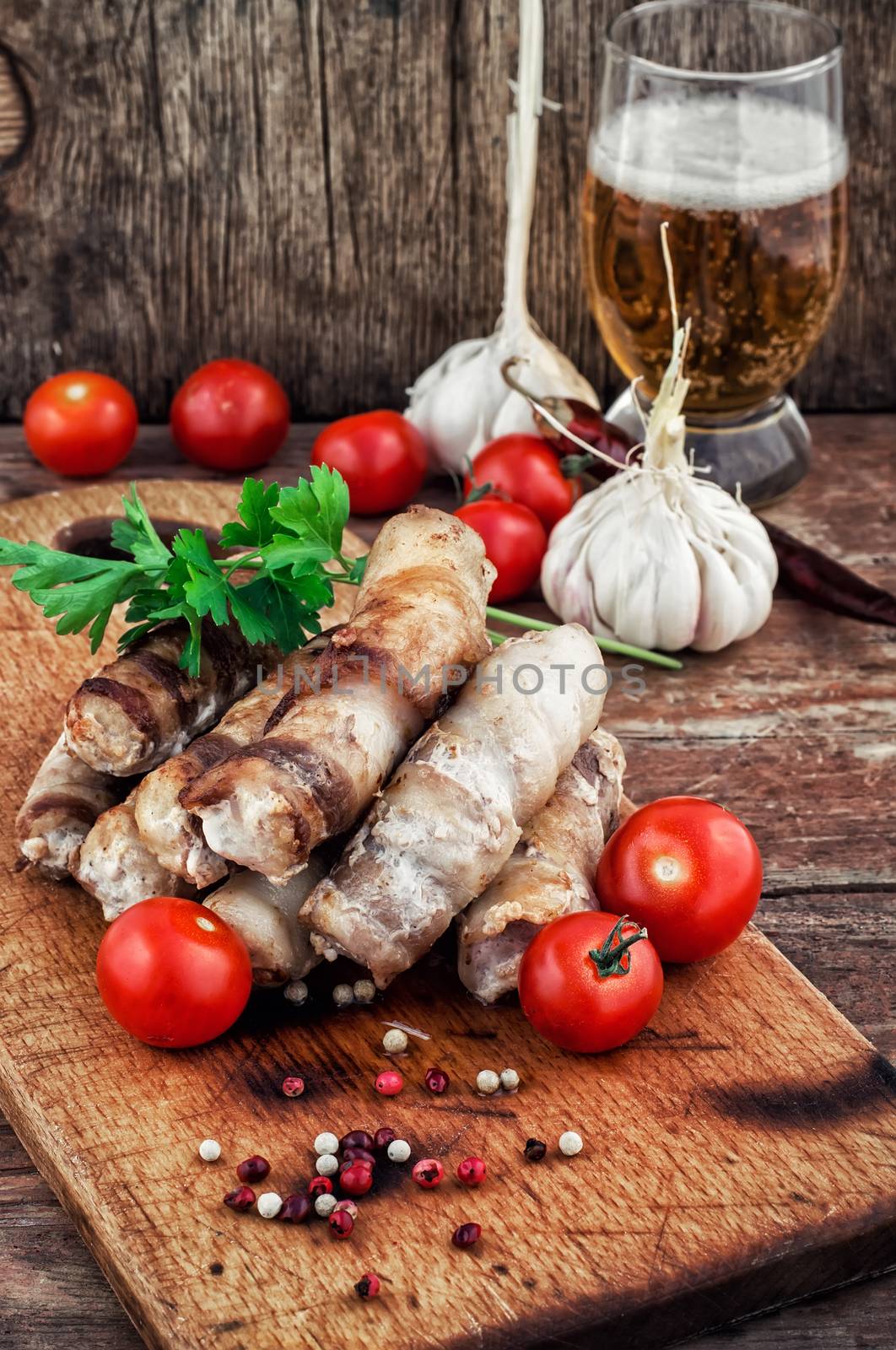 fragrant grilled meat sausages in tomato with a glass of light beer.Selective focus.Photo tinted