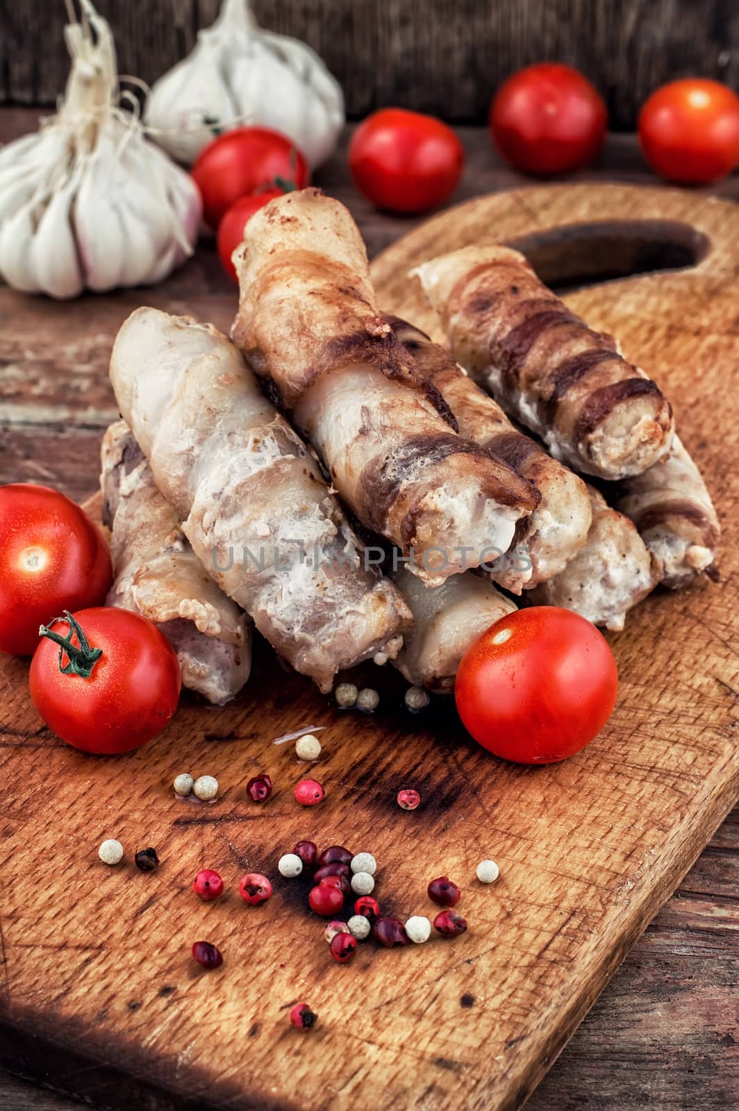 cooked meat products with spices and tomatoes.Selective focus.Photo tinted