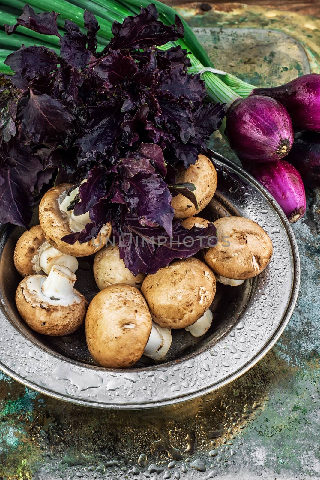 color onions and mushrooms on an iron plate in spray of water.Photo tinted