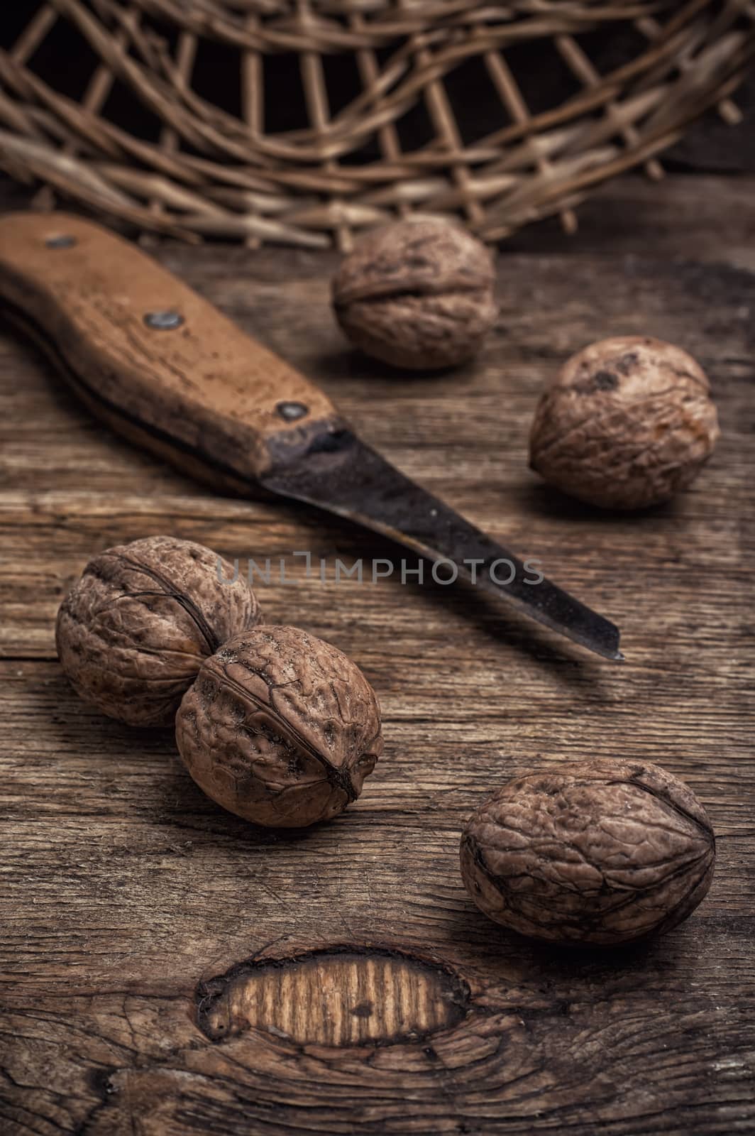 few walnuts on wooden background from autumn harvest.