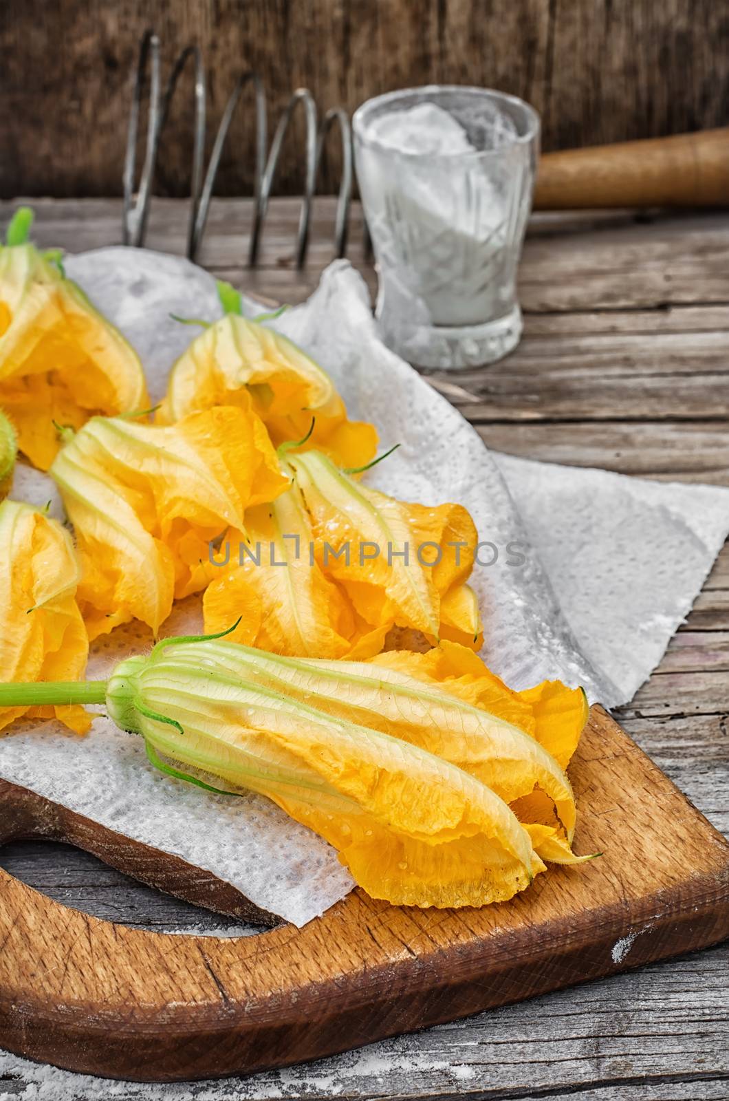 Cooking unusual dishes from pumpkin flowers in batter.Selective focus