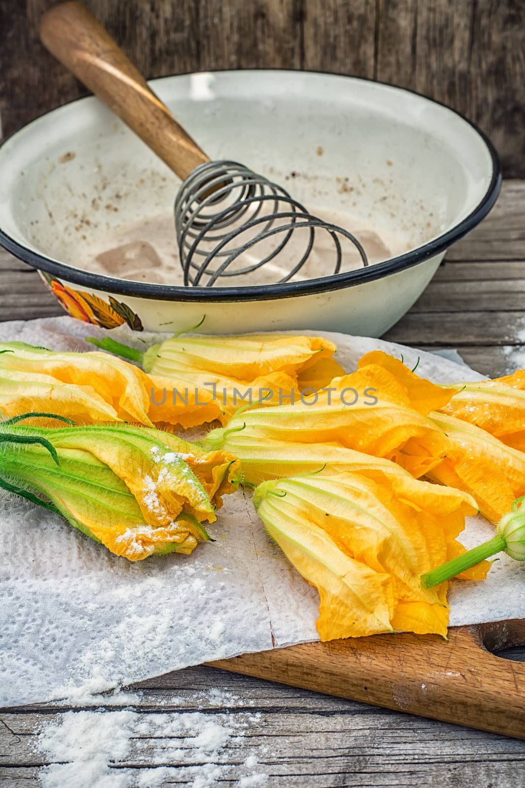 Cooking unusual dishes from pumpkin flowers in batter.Selective focus