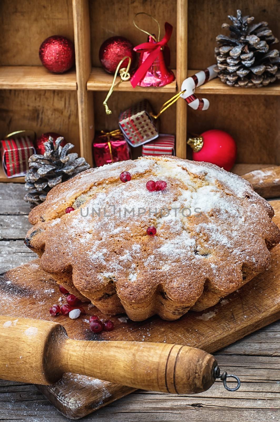 Sweet cupcake baked for the new year holiday on wooden table on  background of Christmas decorations.Photo tinted.Selective focus
