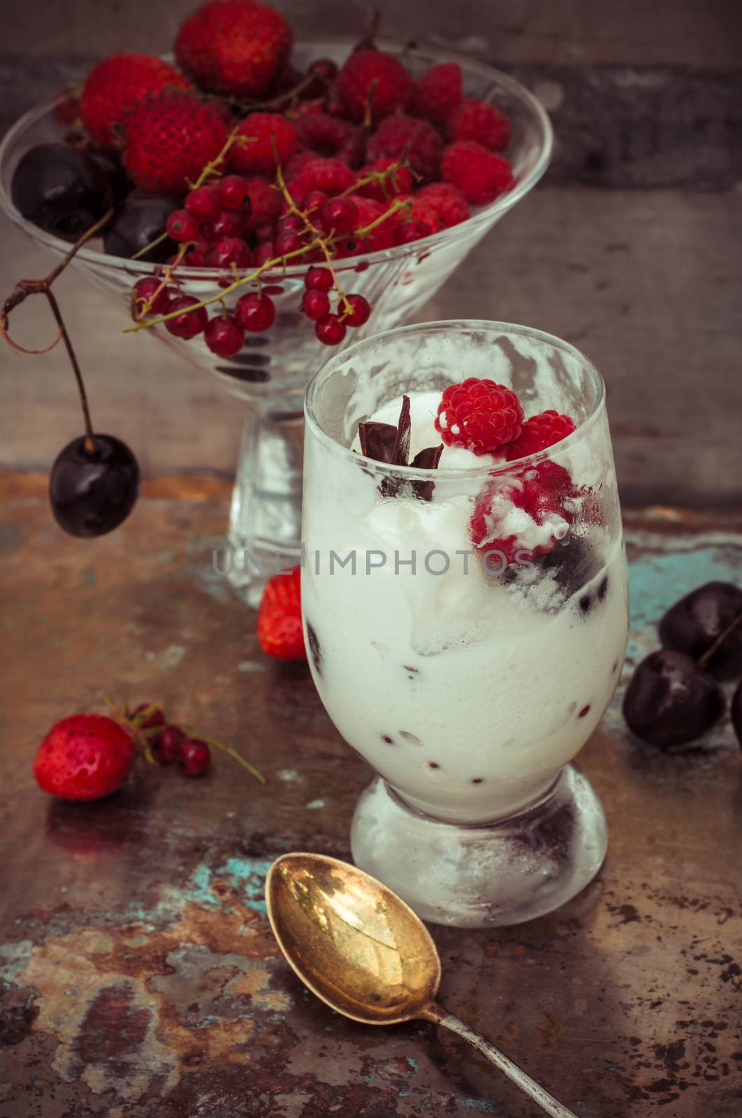 sweet dessert of ice cream per glass and fresh berries, cherries,currants,strawberries.Photo tinted.