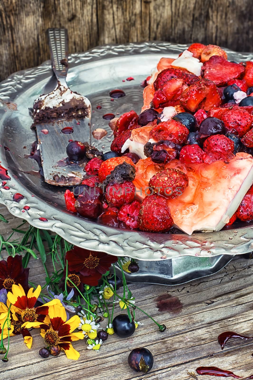 curd jelly cake with strawberries,raspberries and black currants on stand bunk