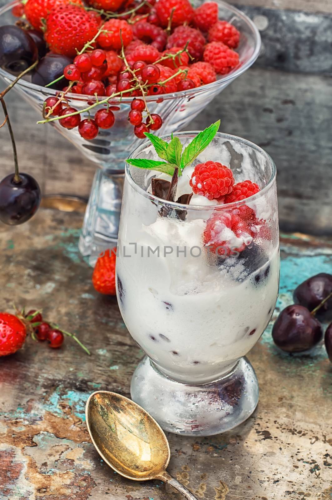 sweet dessert of ice cream per glass and fresh berries, cherries,currants,strawberries.