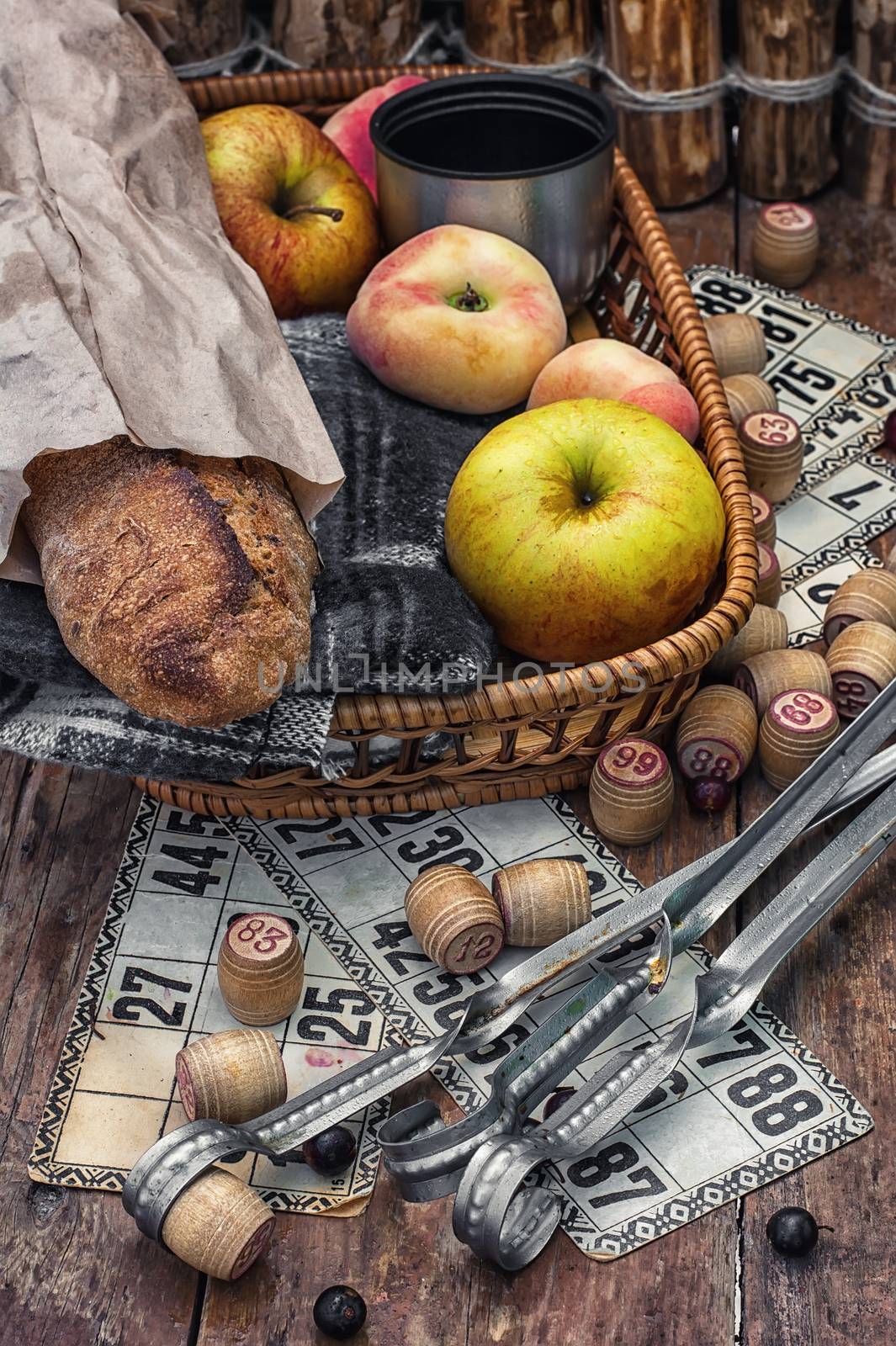 Accessories picnic consisting of peaches,apples and lotto games.Photo tinted.