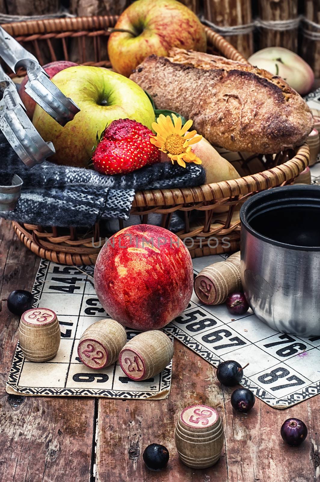 Accessories picnic consisting of peaches,apples and lotto games.Photo tinted.