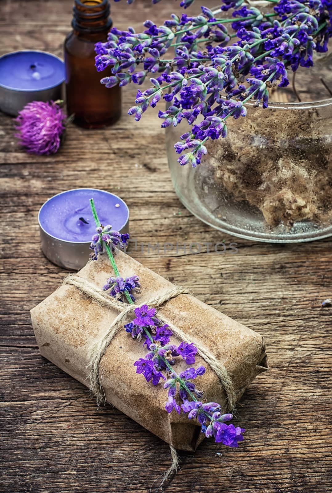candle,flowers lavender oil for spa treatments on wooden background.Photo tinted.Selective focus