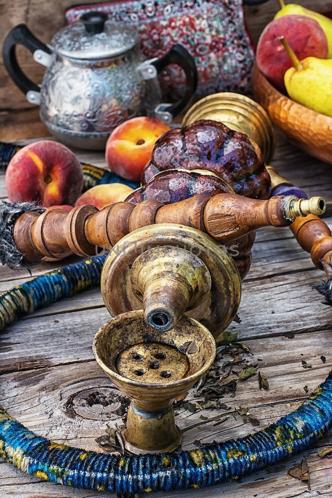 Details were worked hookah on the table amid fresh peaches.Photo tinted.Selective focus