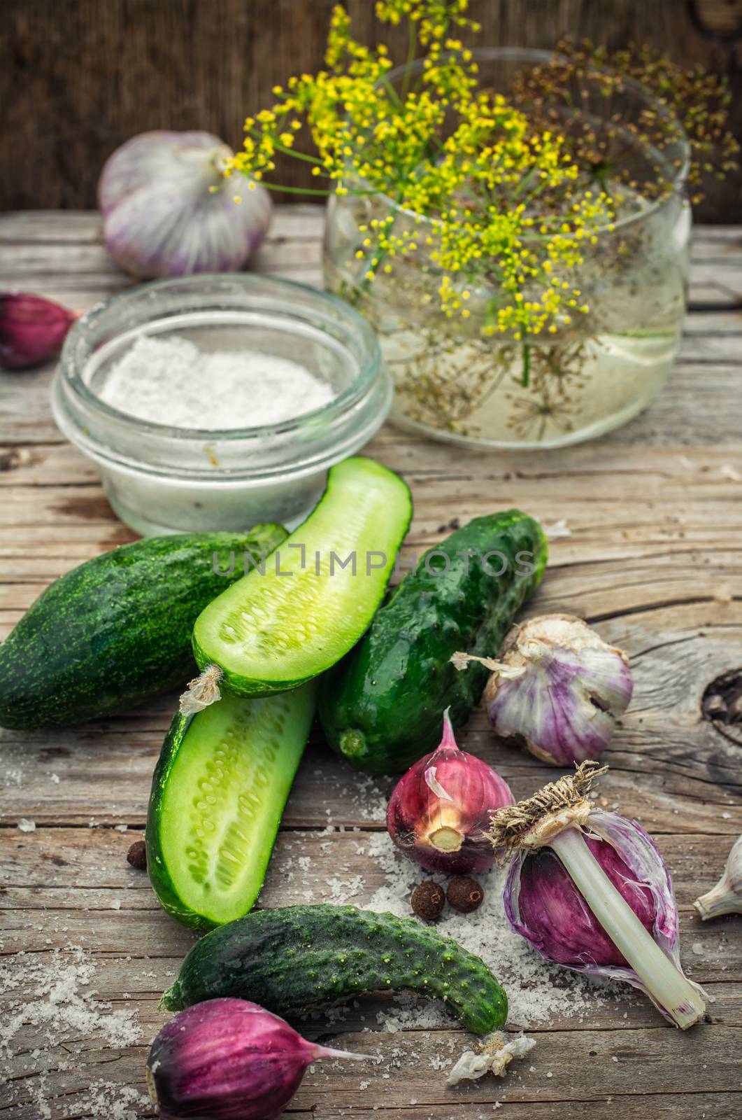 Cucumber pickled with dill and garlic on wooden table.Photo tinted.
