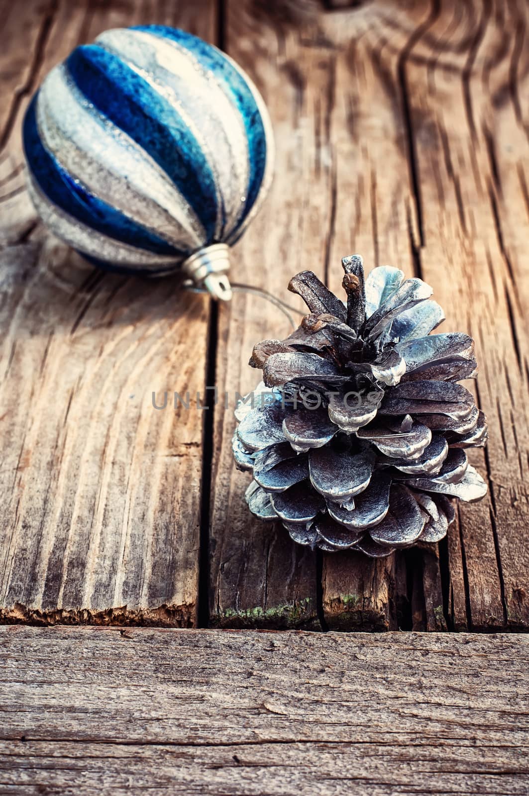 Christmas decorations from pine cones,toys on wooden background.Photo tinted