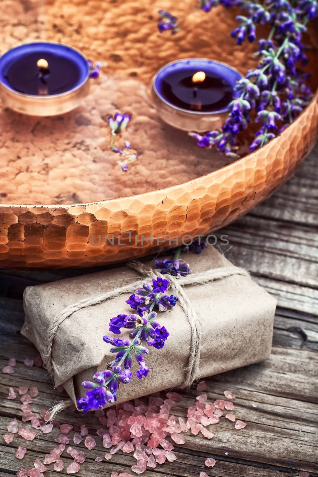 bronze receptacle for spa treatments and floating candles in it.Photo tinted.Selective focus