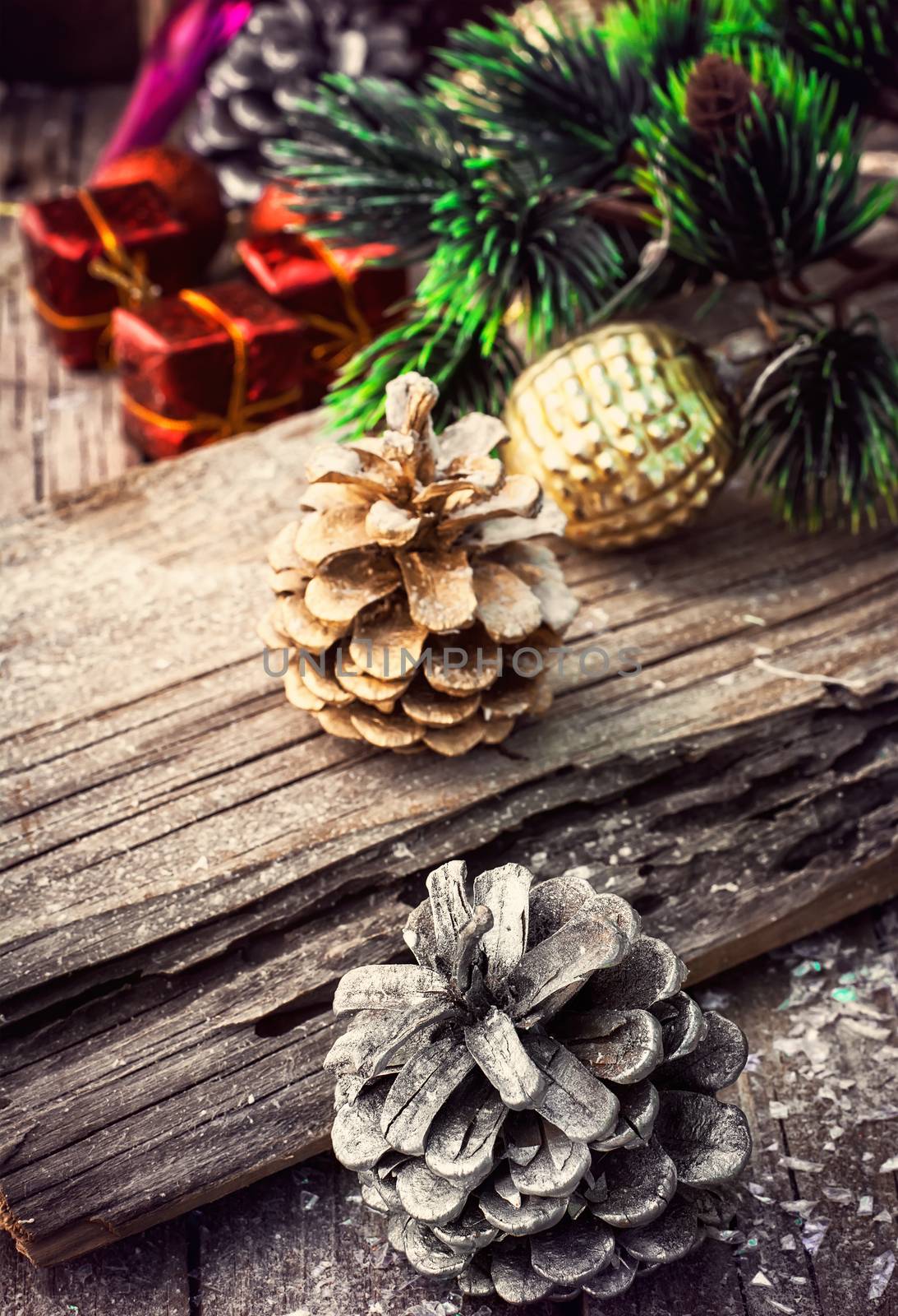 Christmas decorations with toys and cones on wooden plane.Photo tinted.