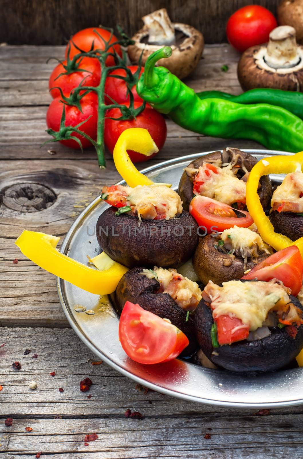 Easy appetizer of mushrooms stuffed with cheese,garlic and tomatoes.Rustic kitchen.Photo tinted.Selective focus