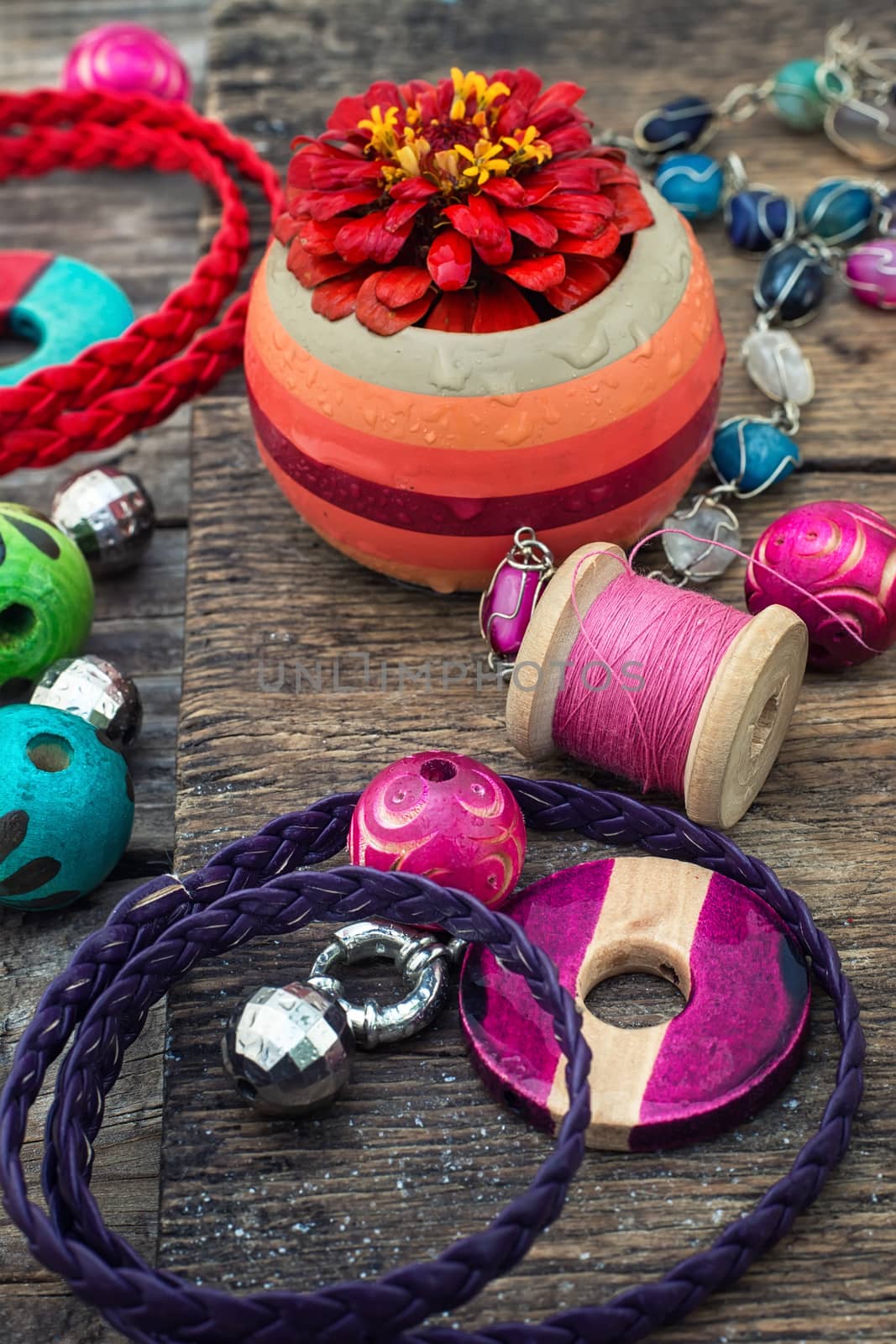 Wooden beads and accessories for needlework on old wooden  background