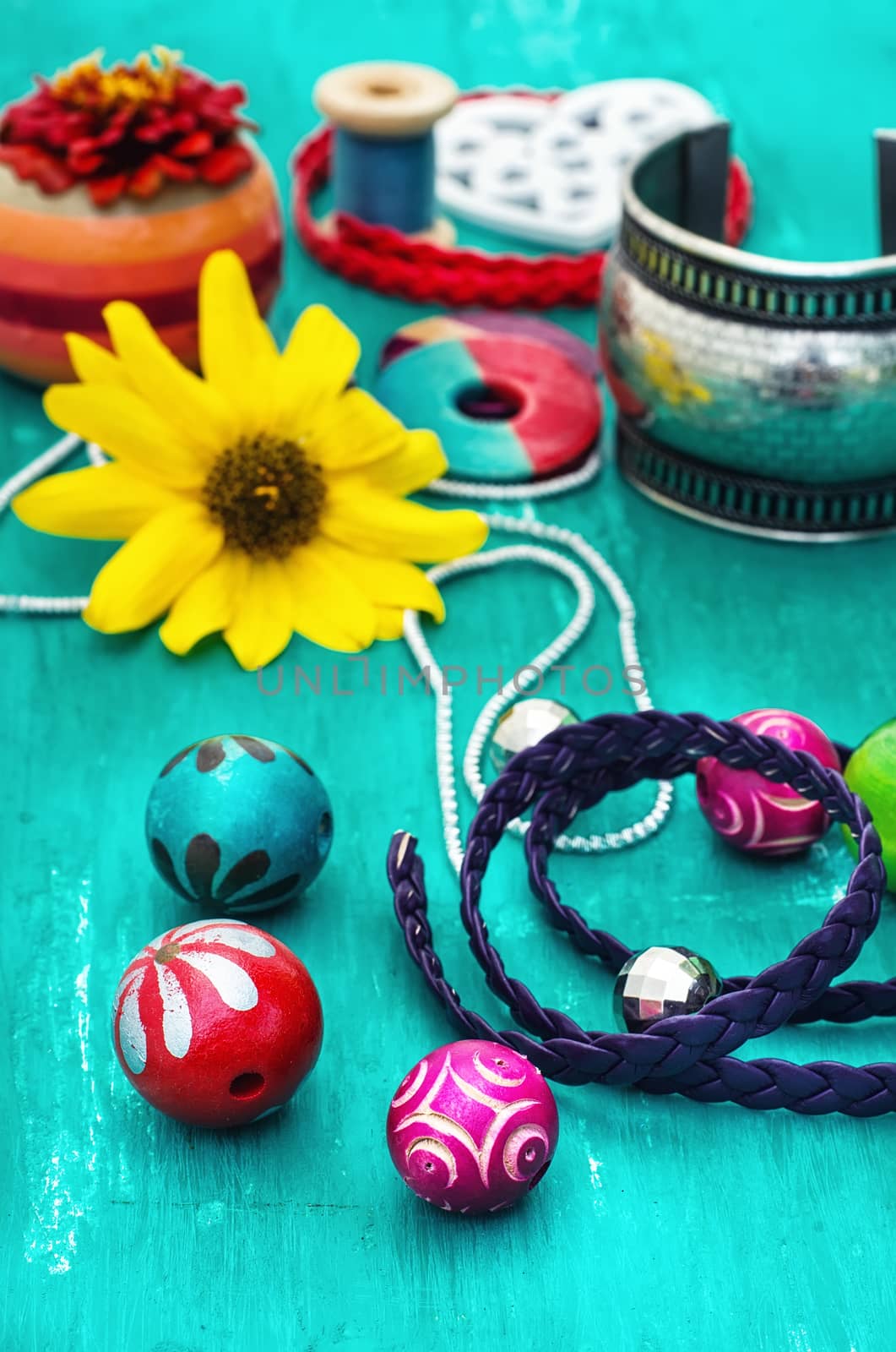 Wooden beads and accessories for needlework on old wooden  background