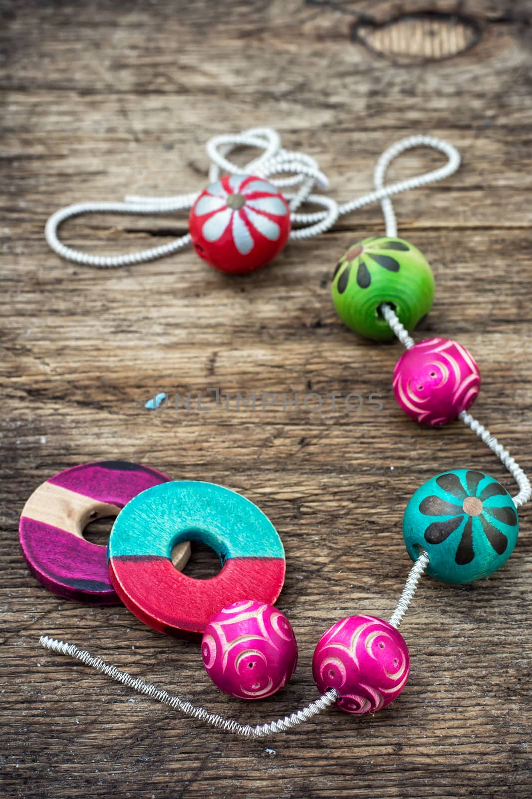 Wooden beads and accessories for needlework on old wooden  background