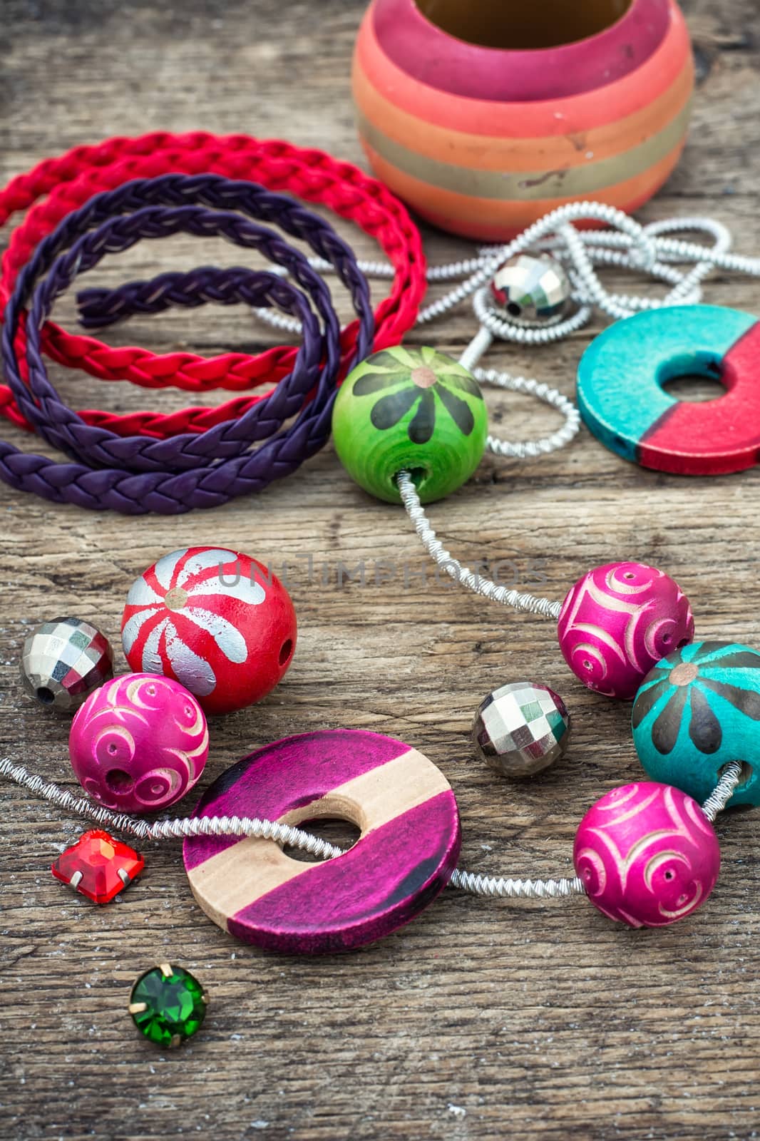 Wooden beads and accessories for needlework on old wooden  background