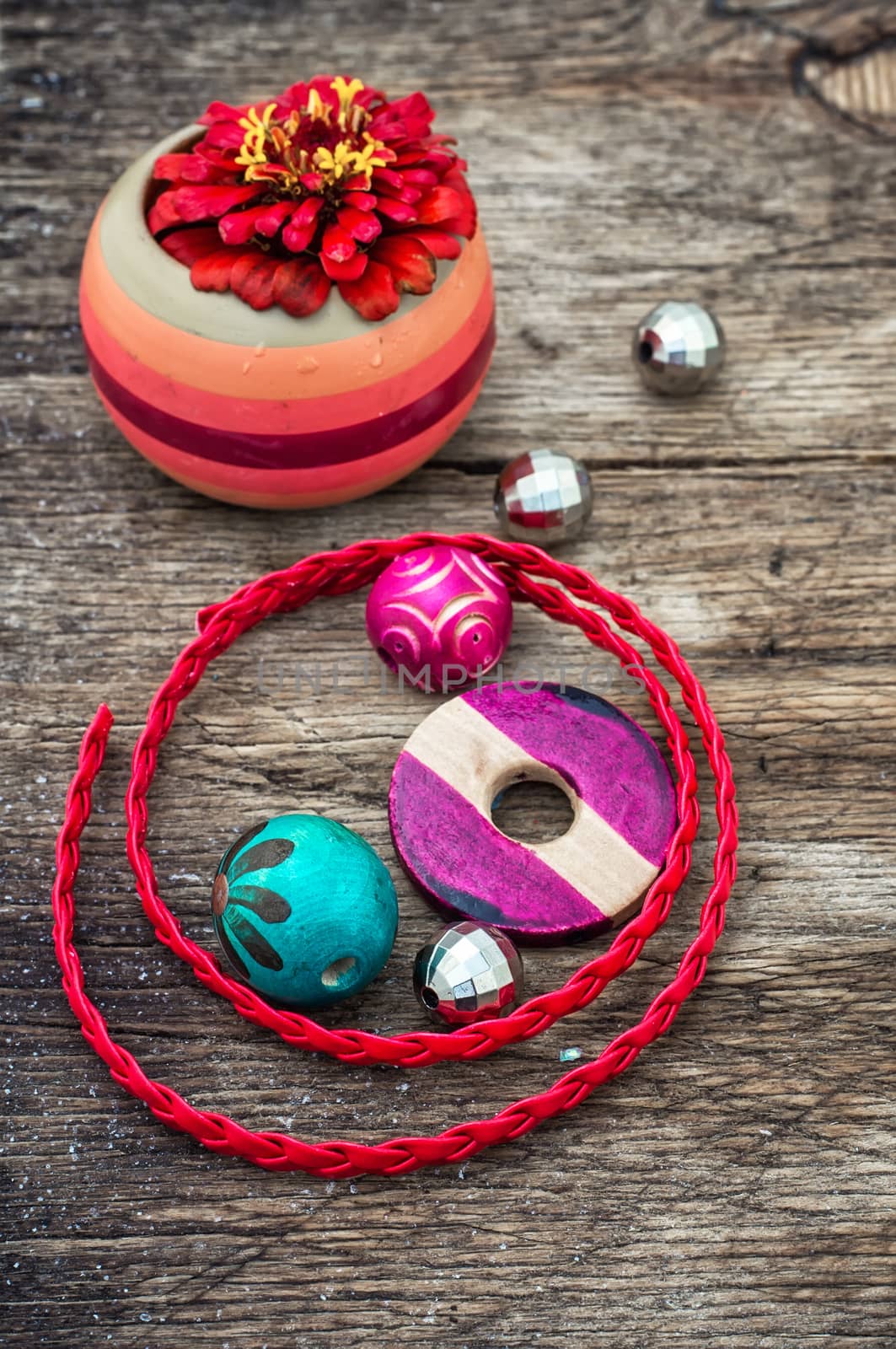 Wooden beads and accessories for needlework on old wooden  background