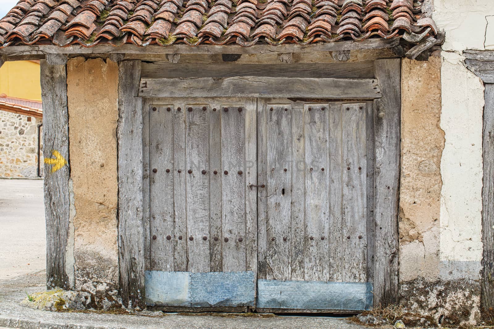 Old rustic wooden door in grey color 