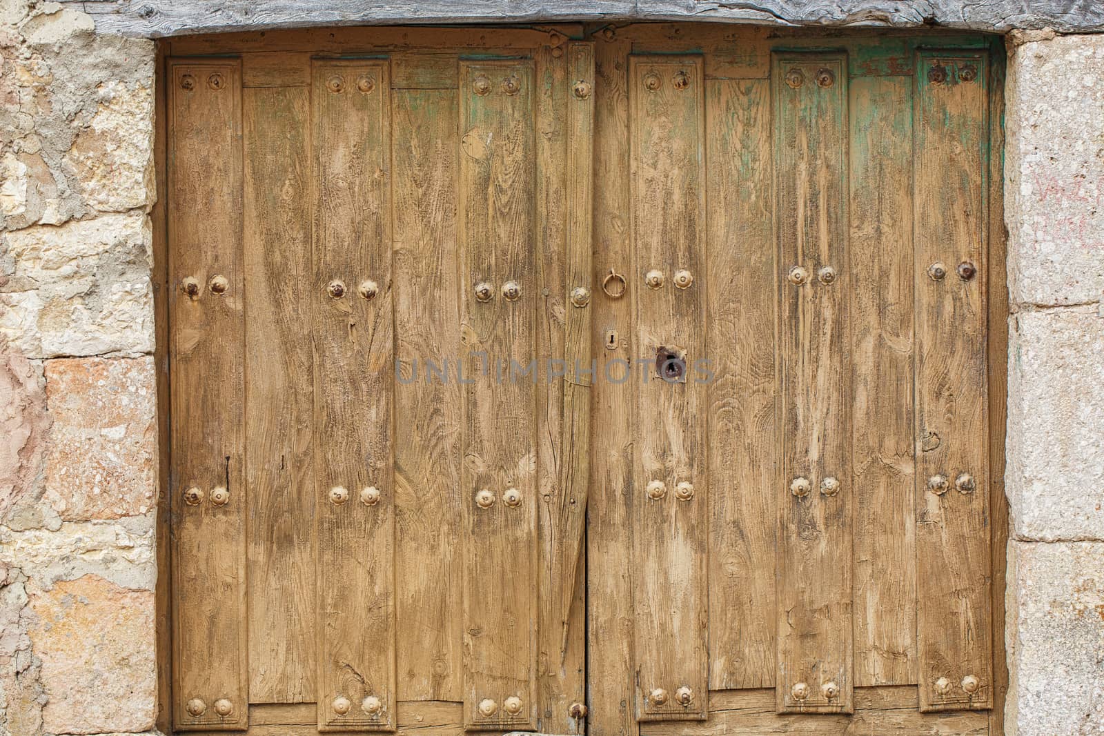 Old rustic wooden brown door with keyhole