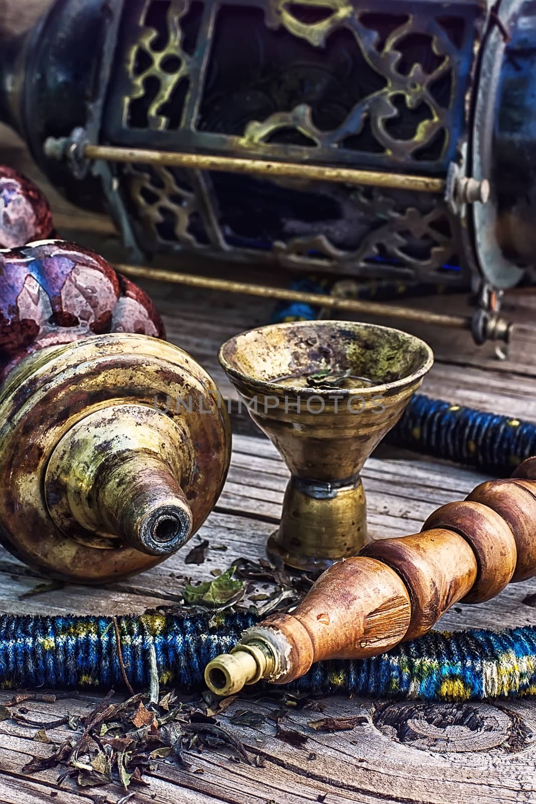 Old smoking  hookah on wooden surface.Photo tinted