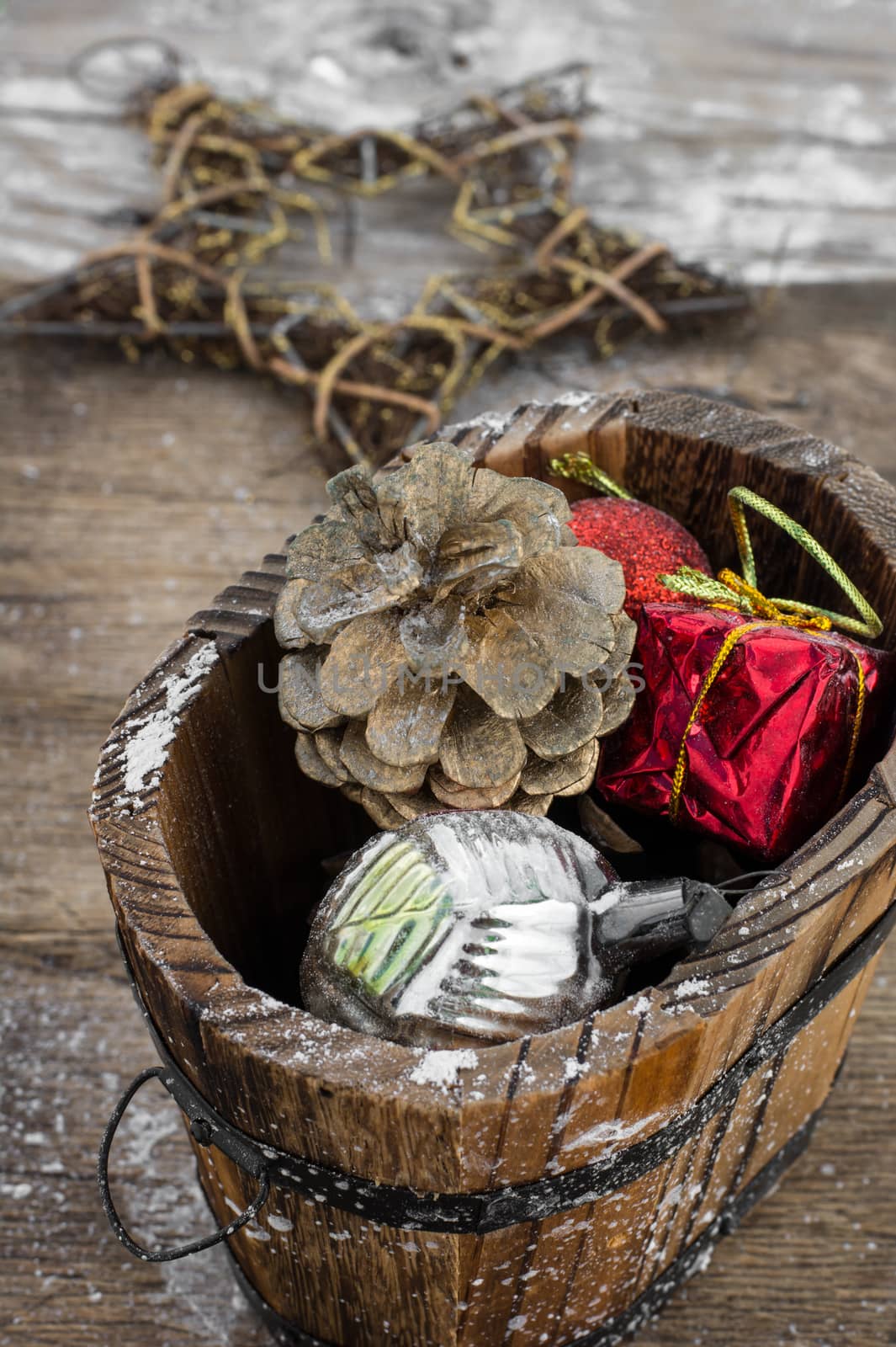 wooden tub with pine cones and Christmas decorations and ornaments.