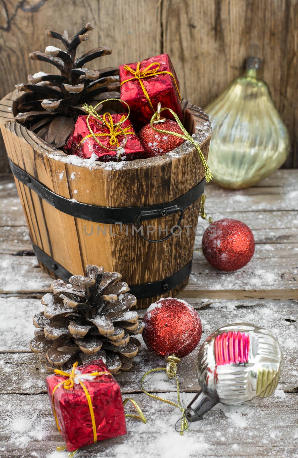wooden tub with pine cones and Christmas decorations and ornaments.