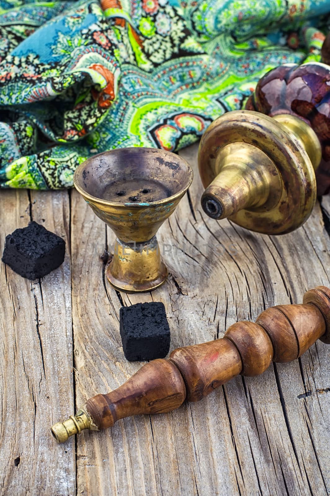 Old smoking  hookah on wooden surface.Photo tinted