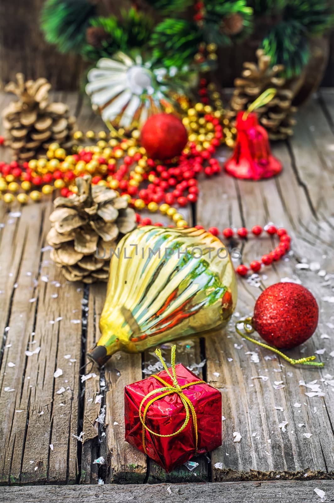 Christmas ornaments and pine cones on wooden background.Photo tinted.