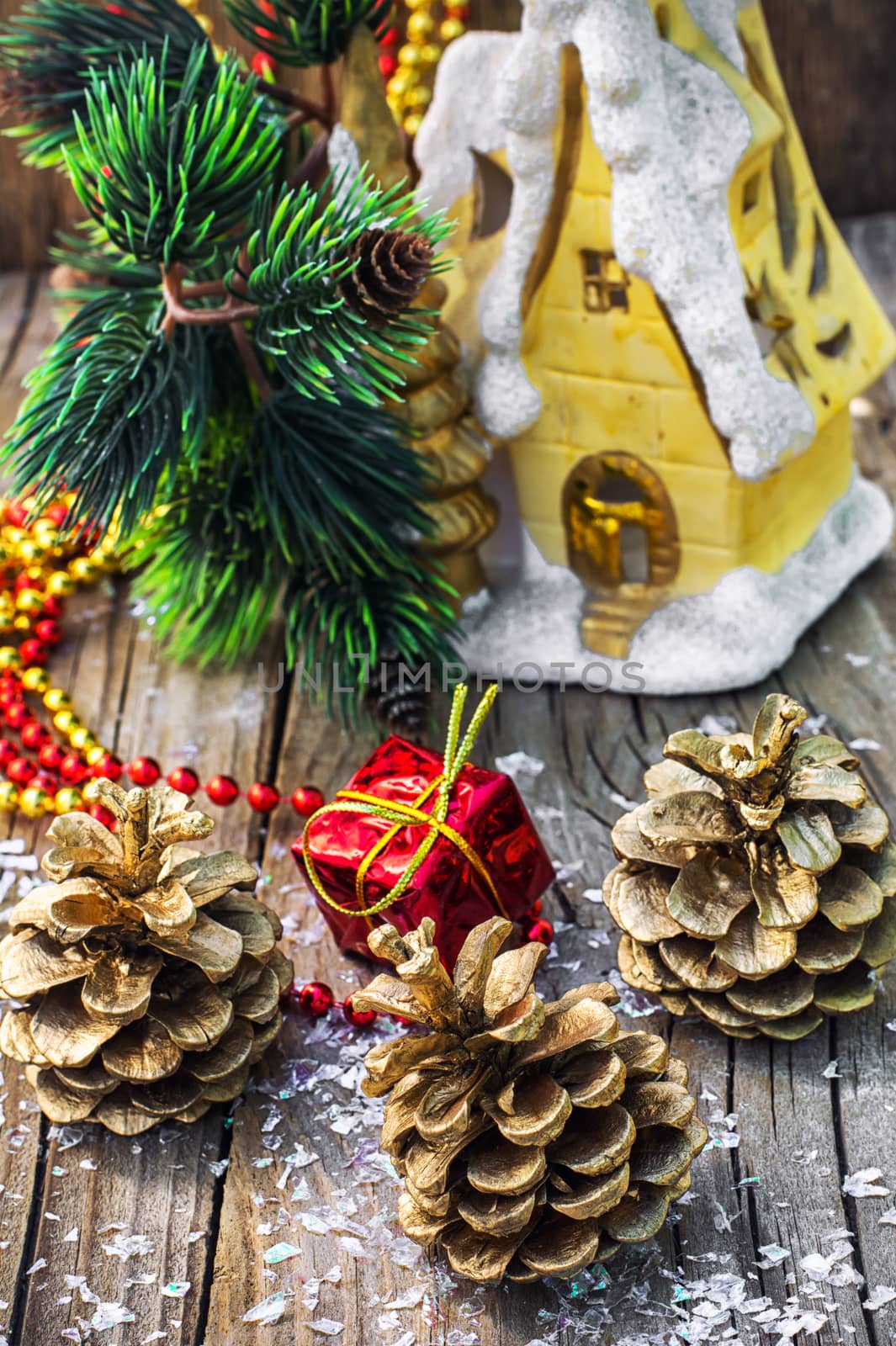 Christmas ornaments and pine cones on wooden background.Photo tinted.