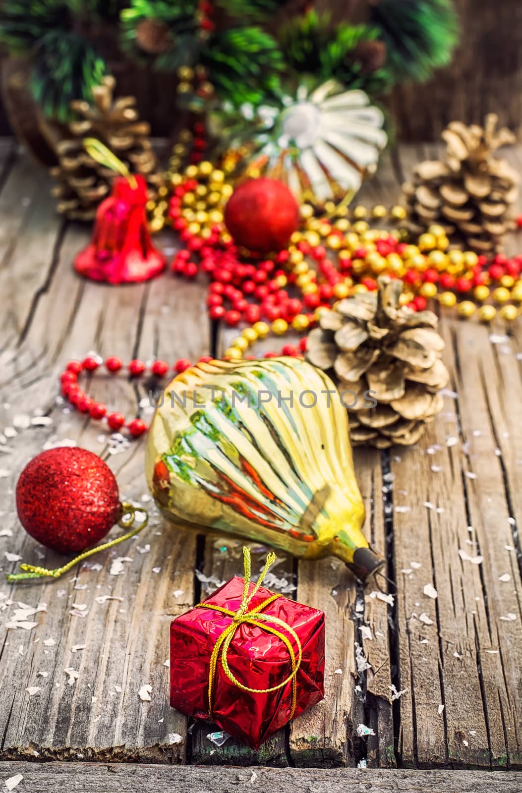Christmas ornaments and pine cones on wooden background.Photo tinted.