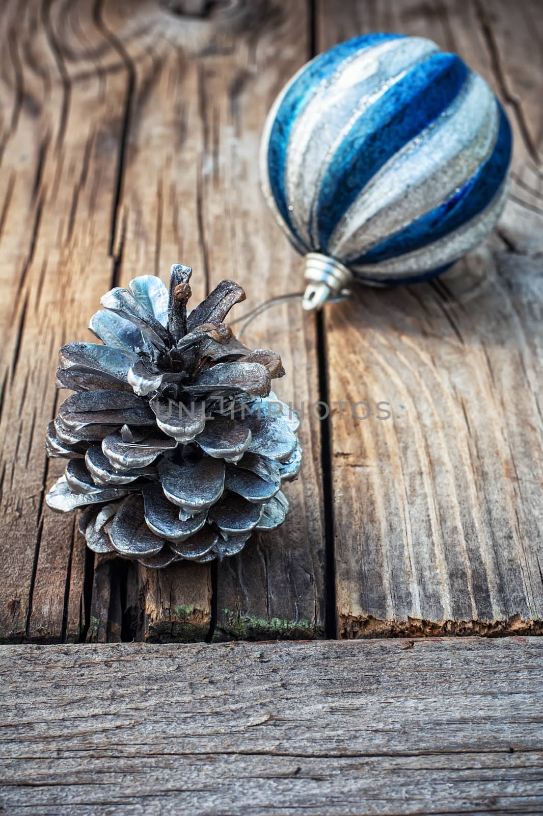 Christmas decorations from pine cones,toys on wooden background.Photo tinted