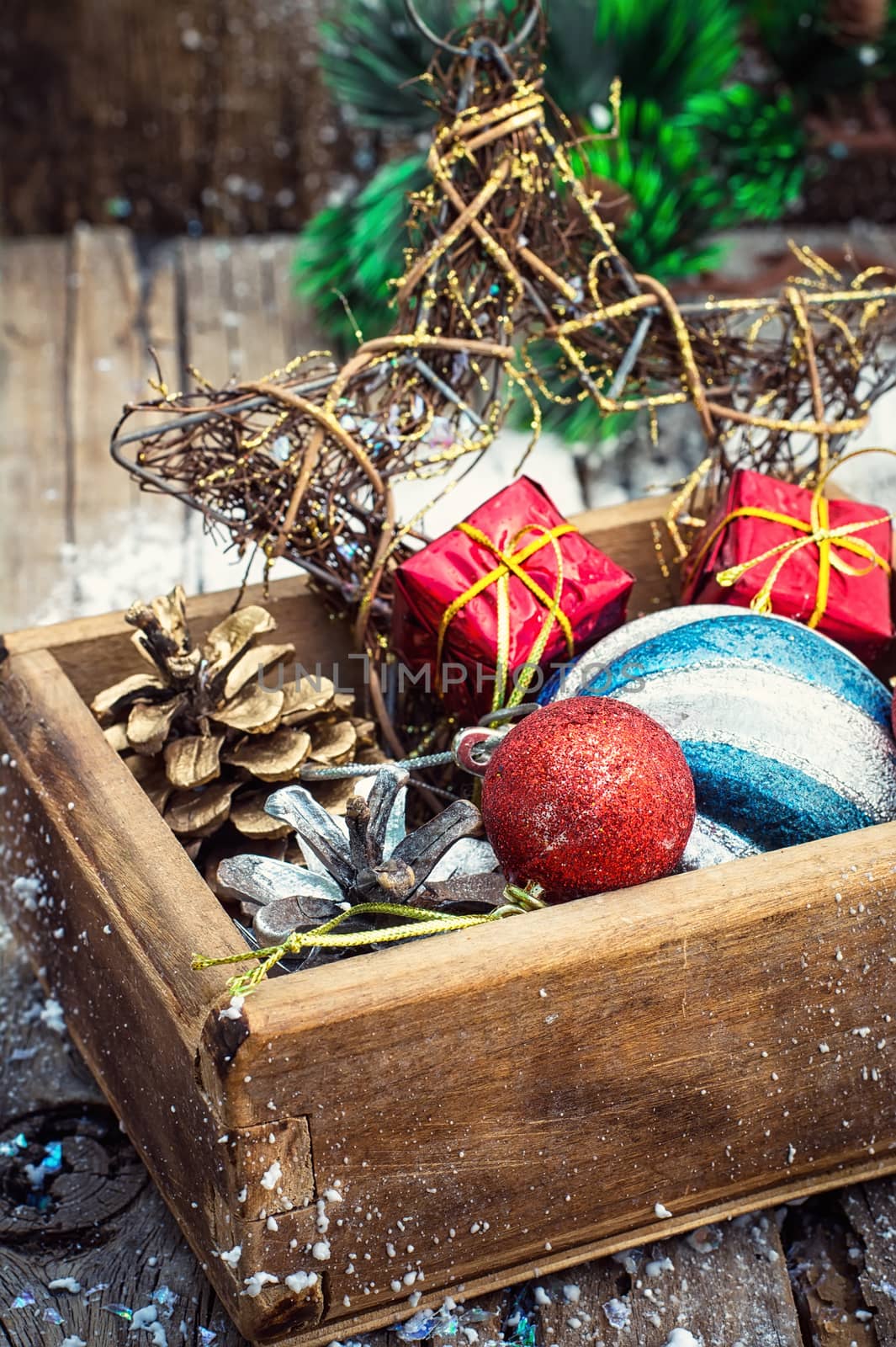 Wooden box filled with old fashion Christmas decorations.Photo tinted.