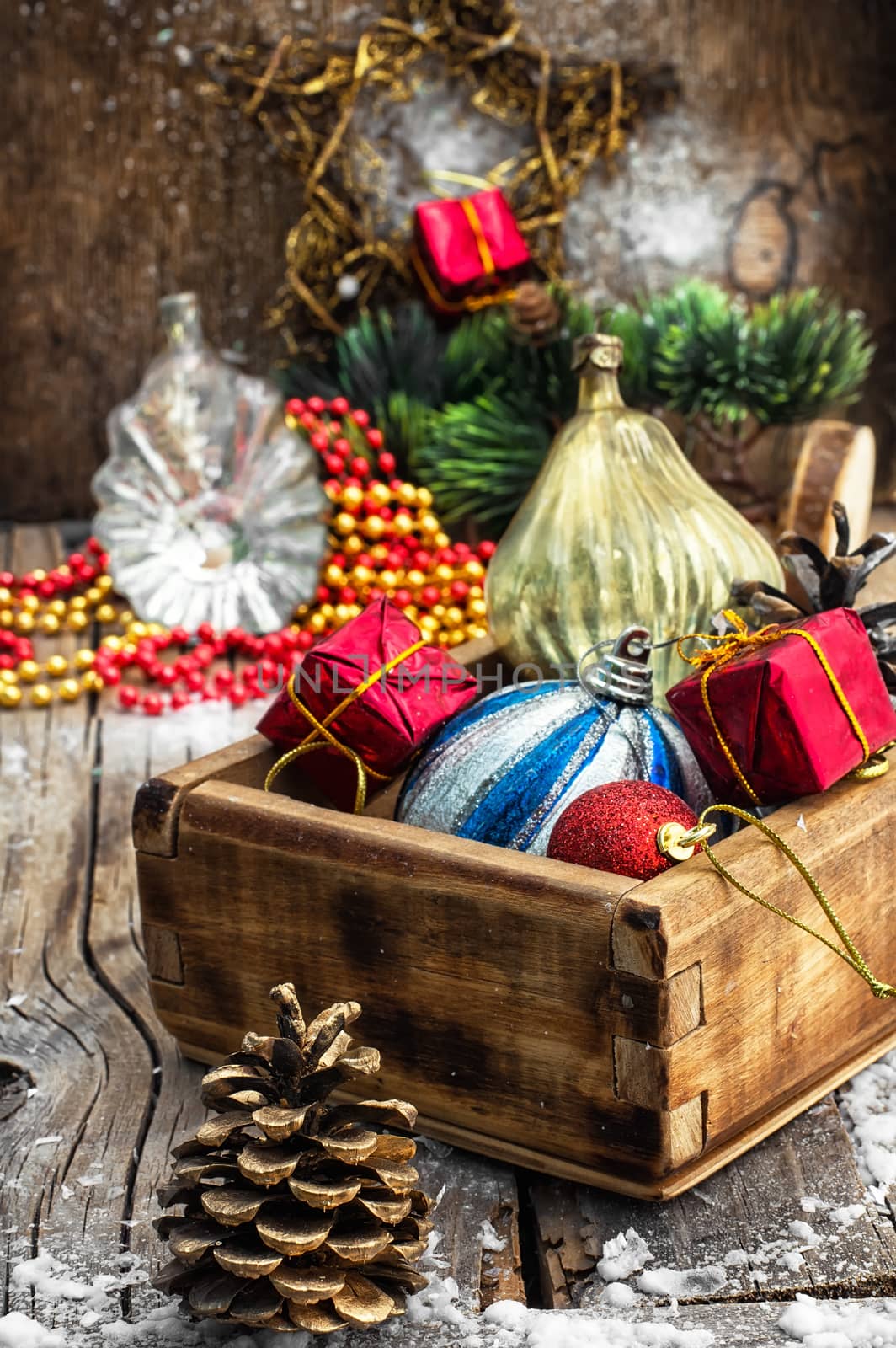 Wooden box filled with old fashion Christmas decorations.Photo tinted.