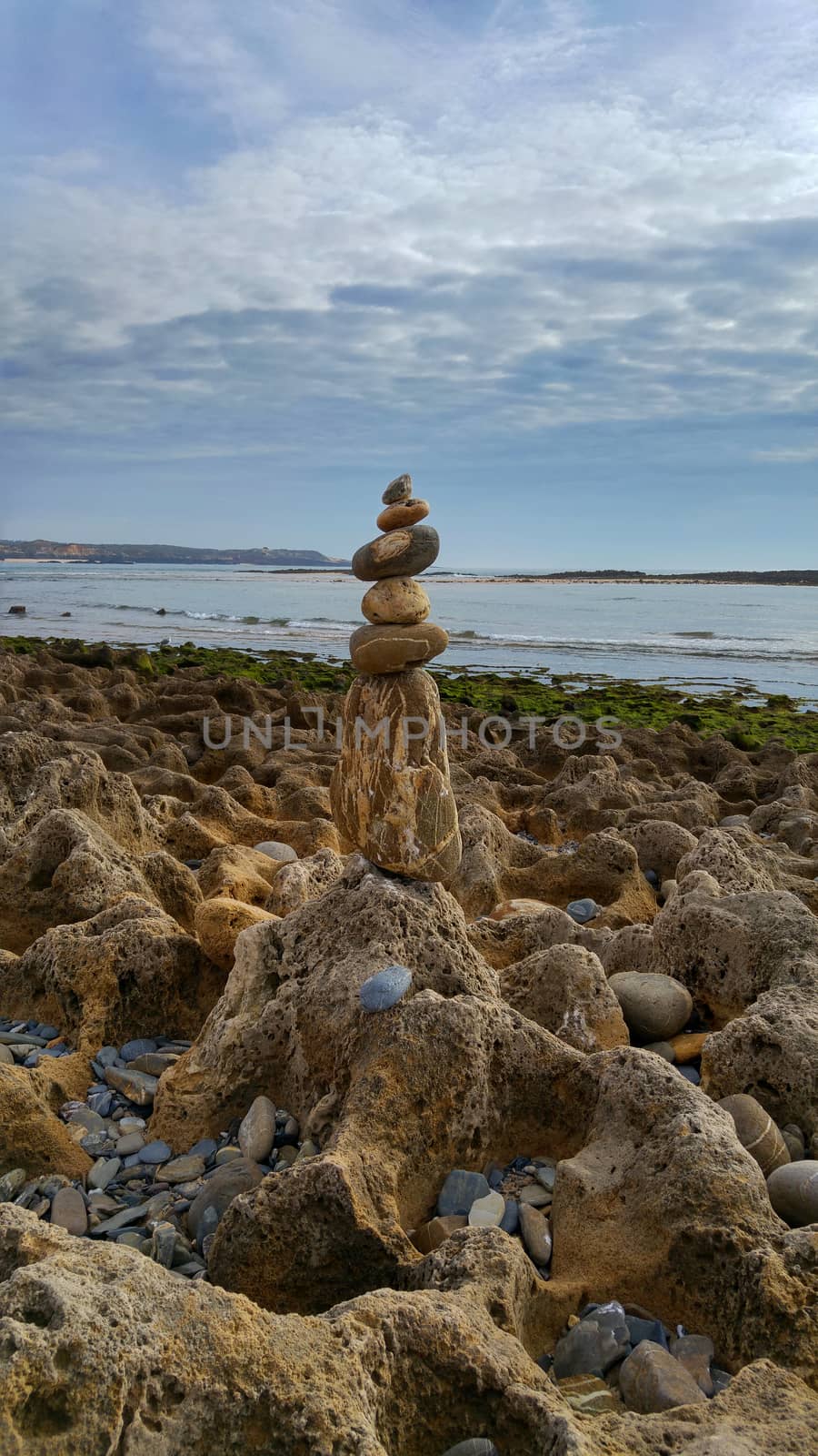 stone stacked pile on the beach of Milfontes in Portugal