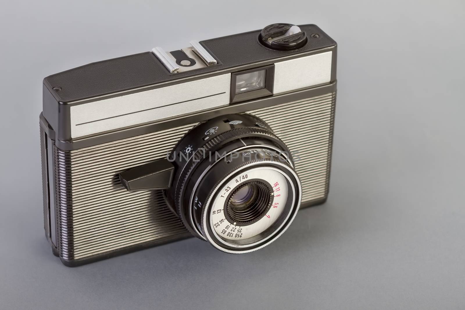 Vintage photo camera on a gray table.
