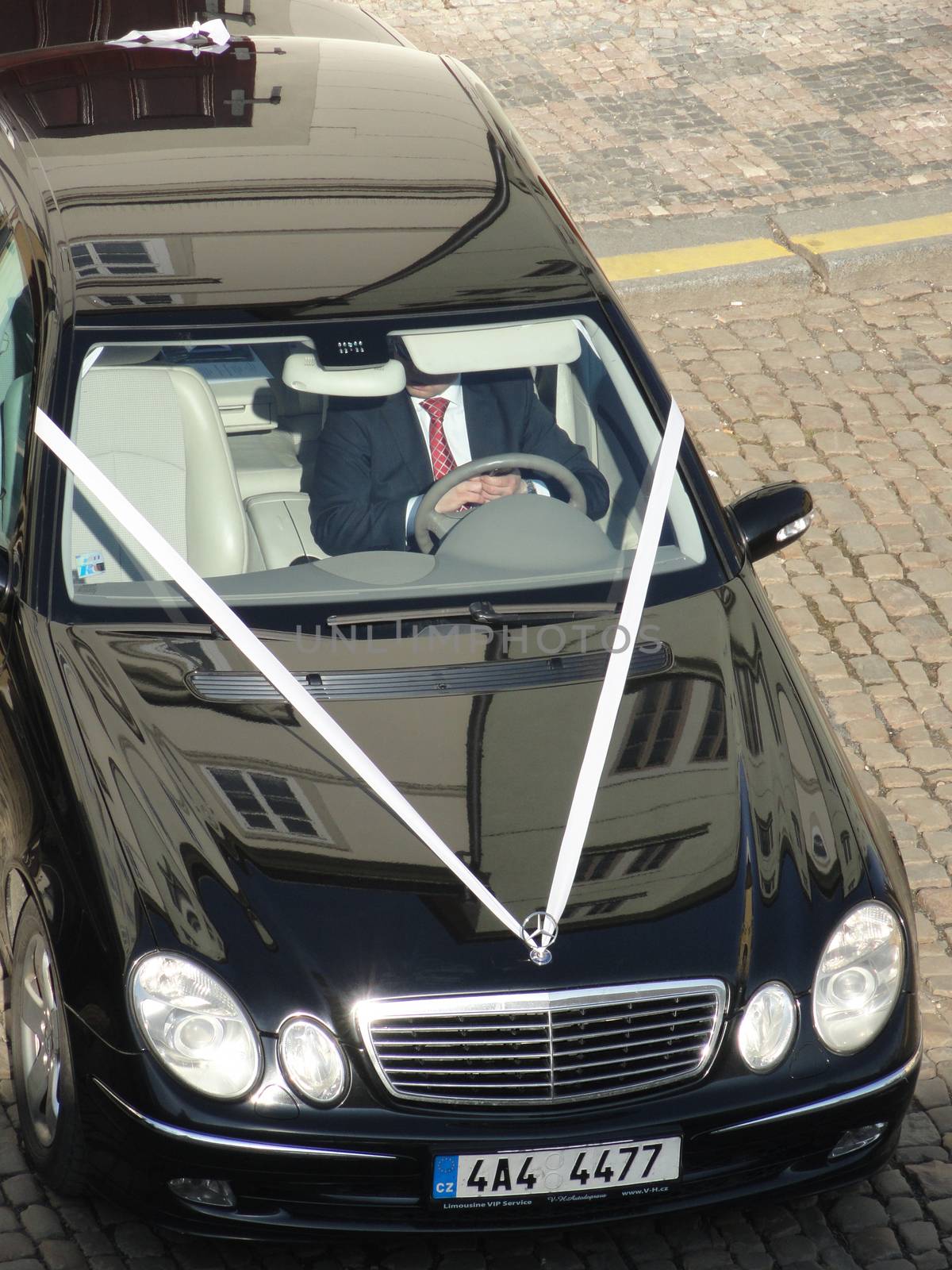 Prague, Czech Republic - February 15 2011: Black Mercedes Wedding Car. The Limo driver was waiting for the Married Couple